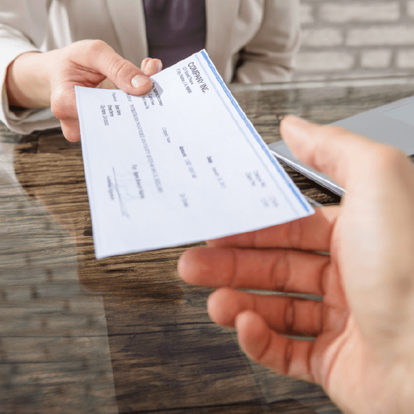 chronically ill person receiving a check after getting a viatical settlement from a viatical provider.
