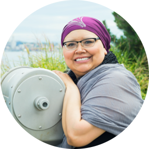 Charlene from Wisconsin, smiling and wearing a purple headband, shares how American Life Fund helped her and her husband during her cancer treatment with viatical settlements 