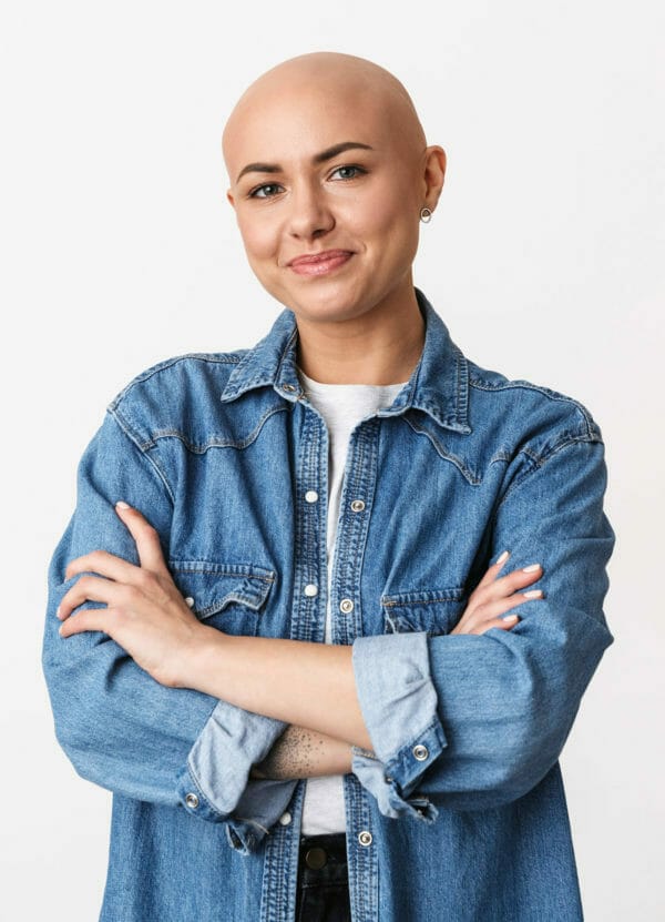 A woman with her arms crossed happy with the alternatives to cancer.