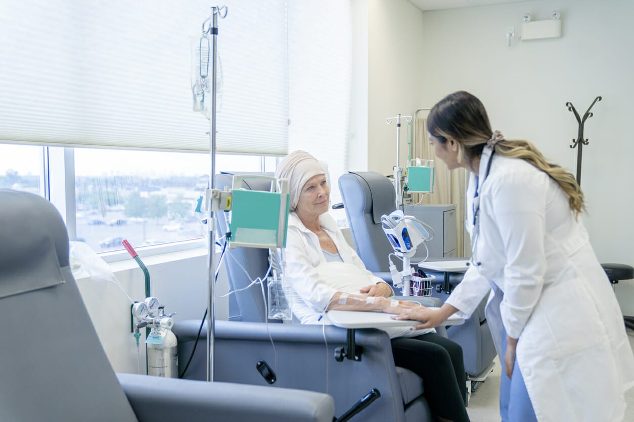 Doctor comforting a leukemia patient receiving chemotherapy, symbolizing financial assistance for leukemia patients.