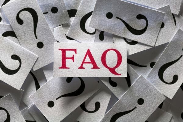 FAQ text surrounded by question marks, indicating common financial assistance queries in North Carolina.