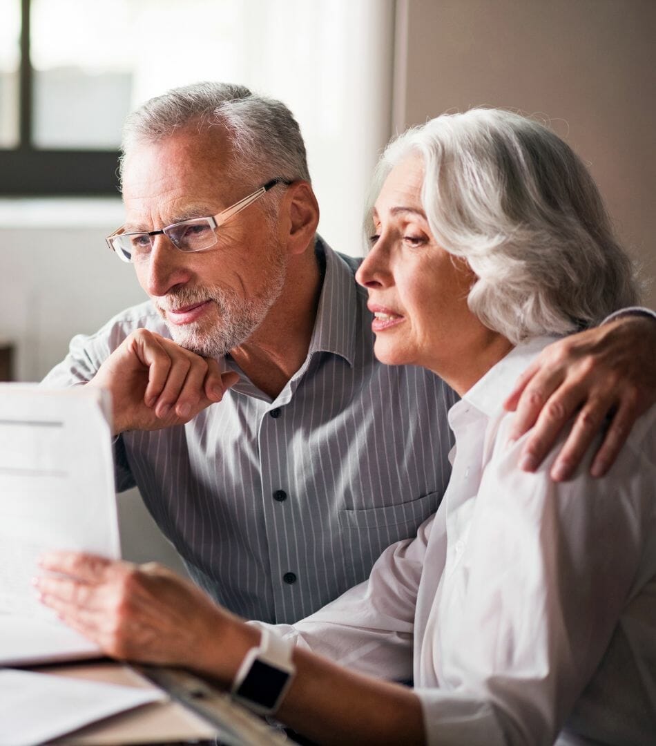 viatical company older couple discussing viatical life settlement with their doctor