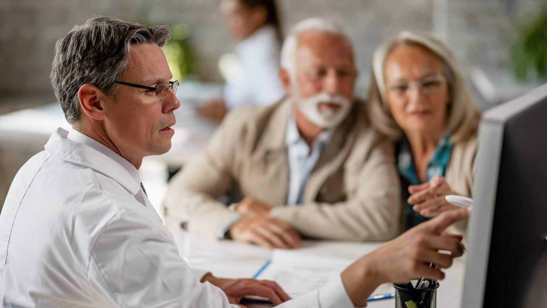 Image of an elderly couple having a consultation with a doctor on their Health Insurance Options 