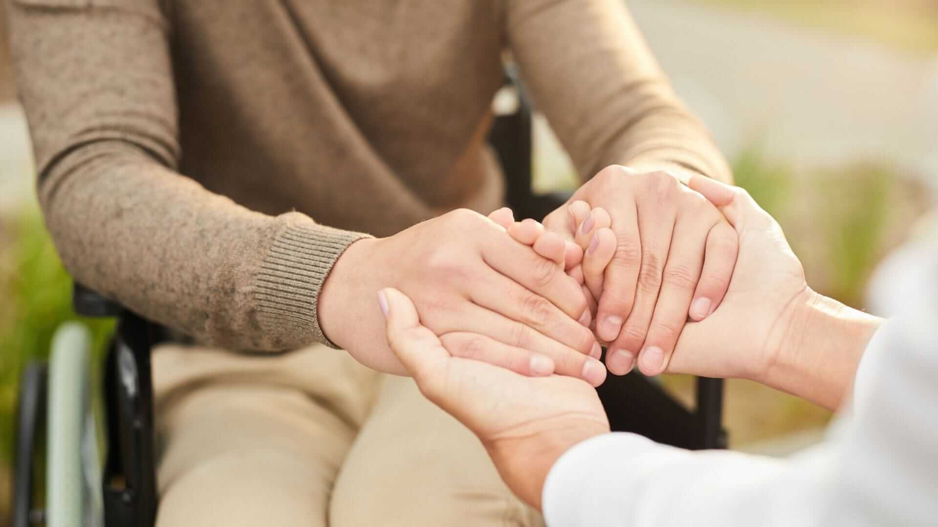 Image of two people holding hands 